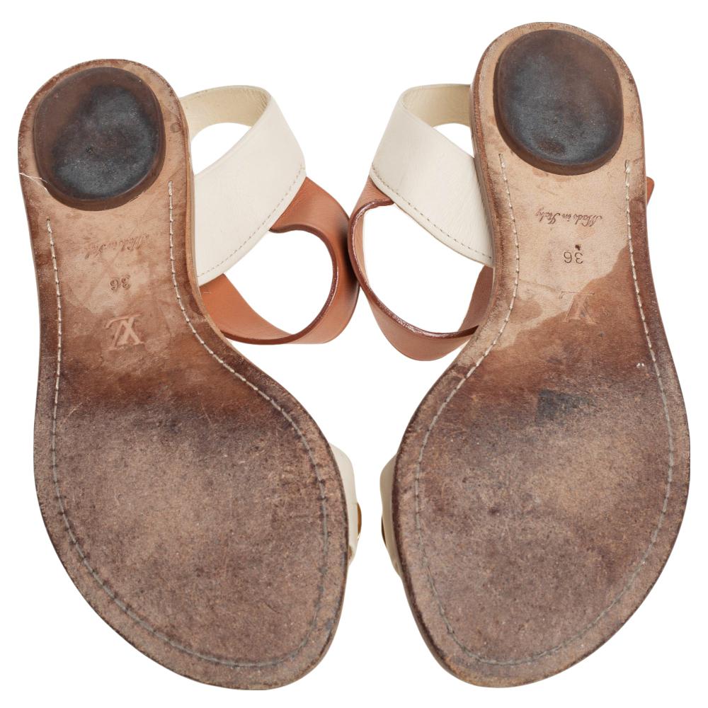 Ideal for a trendy appeal, these stylish sandals by Louis Vuitton are crafted using leather. They come with dual hues and are accentuated with eyelets. An open-toe design elevates the overall look. They make excellent picks for a sleek look, that
