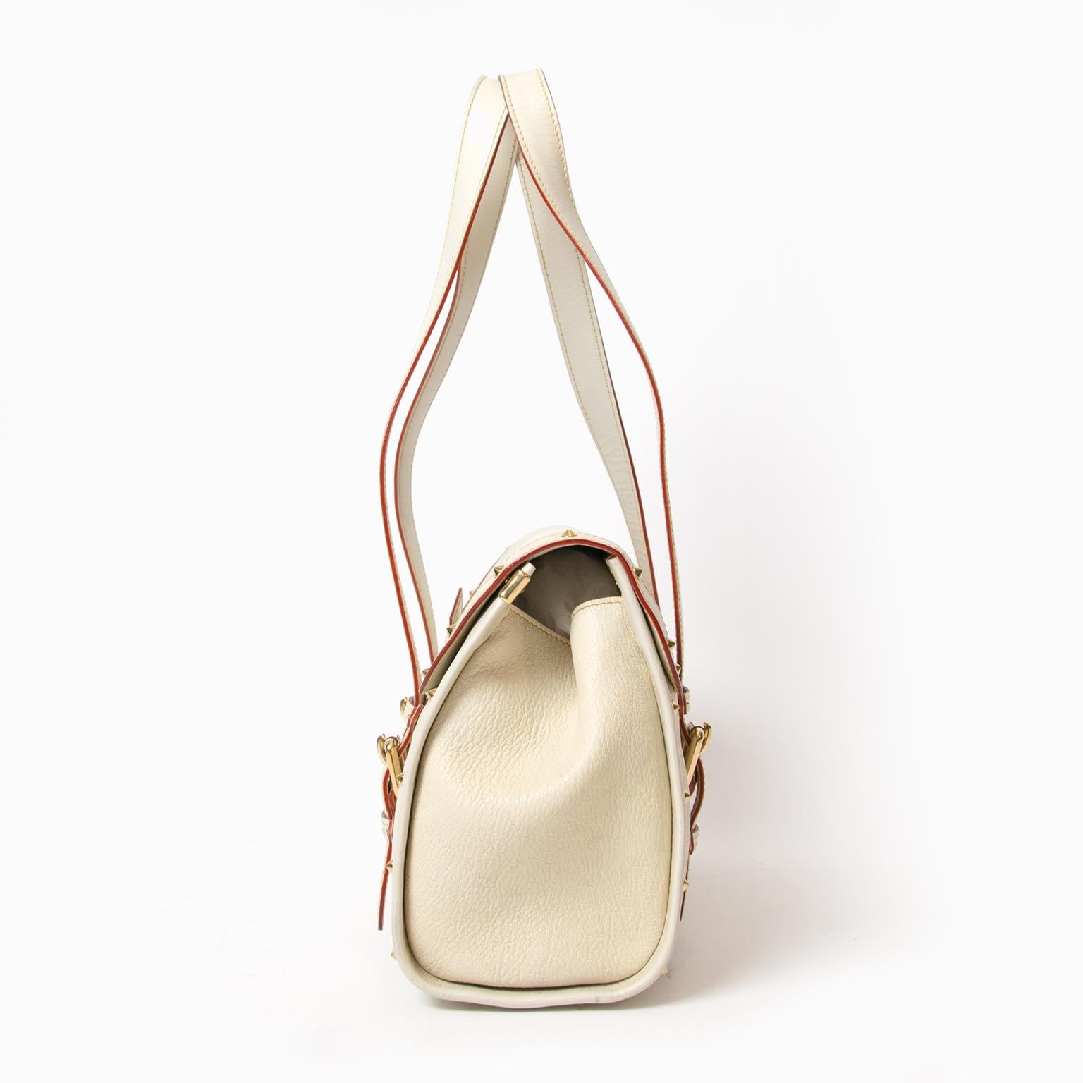 This feminine Louis Vuitton White Suhali Leather L'Epanoui GM Bag is one exquisite bag. It is made of the finest goat leather and has been impeccably handcrafted to create this modern classic style with incredible studded details. A perfectly