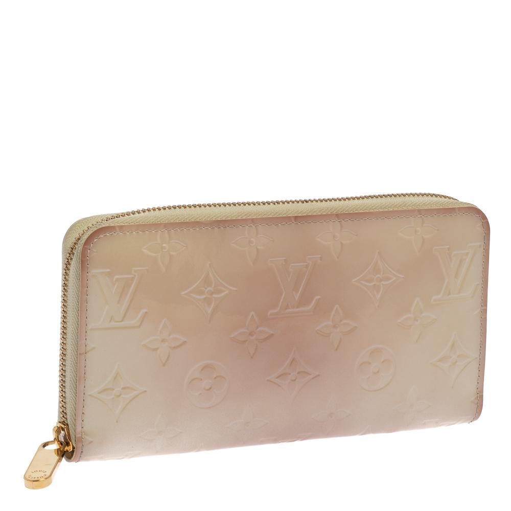 Designed in a cream white hue color, this wallet is a shimmering beauty. Its Monogram Vernis exterior is embossed with the LV signature motifs and features an all-around zip closure. Lined with leather, its interior includes multiple compartments