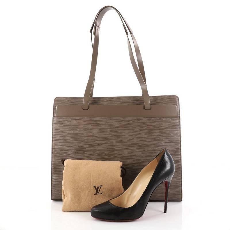 This authentic Louis Vuitton Croisette Handbag Epi Leather GM is refined and elegantly constructed. Crafted from taupe epi leather, this rectangular silhouette features structured base, dual long thin leather handles and matte silver-tone hardware