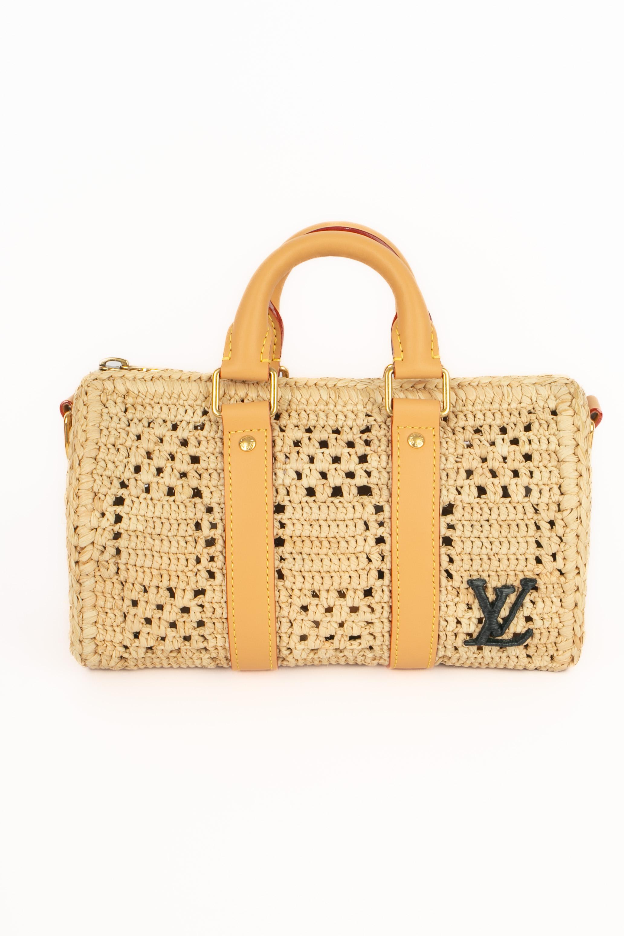 LOUIS VUITTON - (Made in Madagascar) 25cm crossbody 'Keepall' bag made of natural palm tree fibers by hand. The tailoring of the hull took about 40 hours. Weaved checked pattern and natural leather finishing, black raffia initials made by hand,