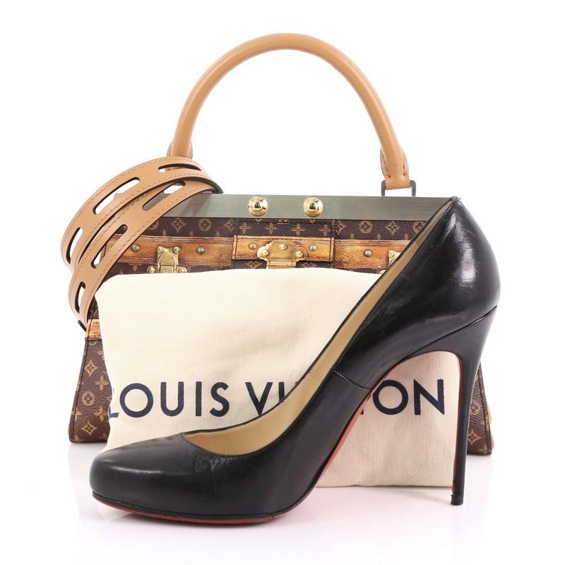 This Louis Vuitton Crown Frame Tote Limited Edition Time Trunk Monogram Canvas, crafted from coated canvas in trompe l'oeil luggage trunk look, features a rolled leather top handles and gold and silver-tone hardware. Its silver top bar with press