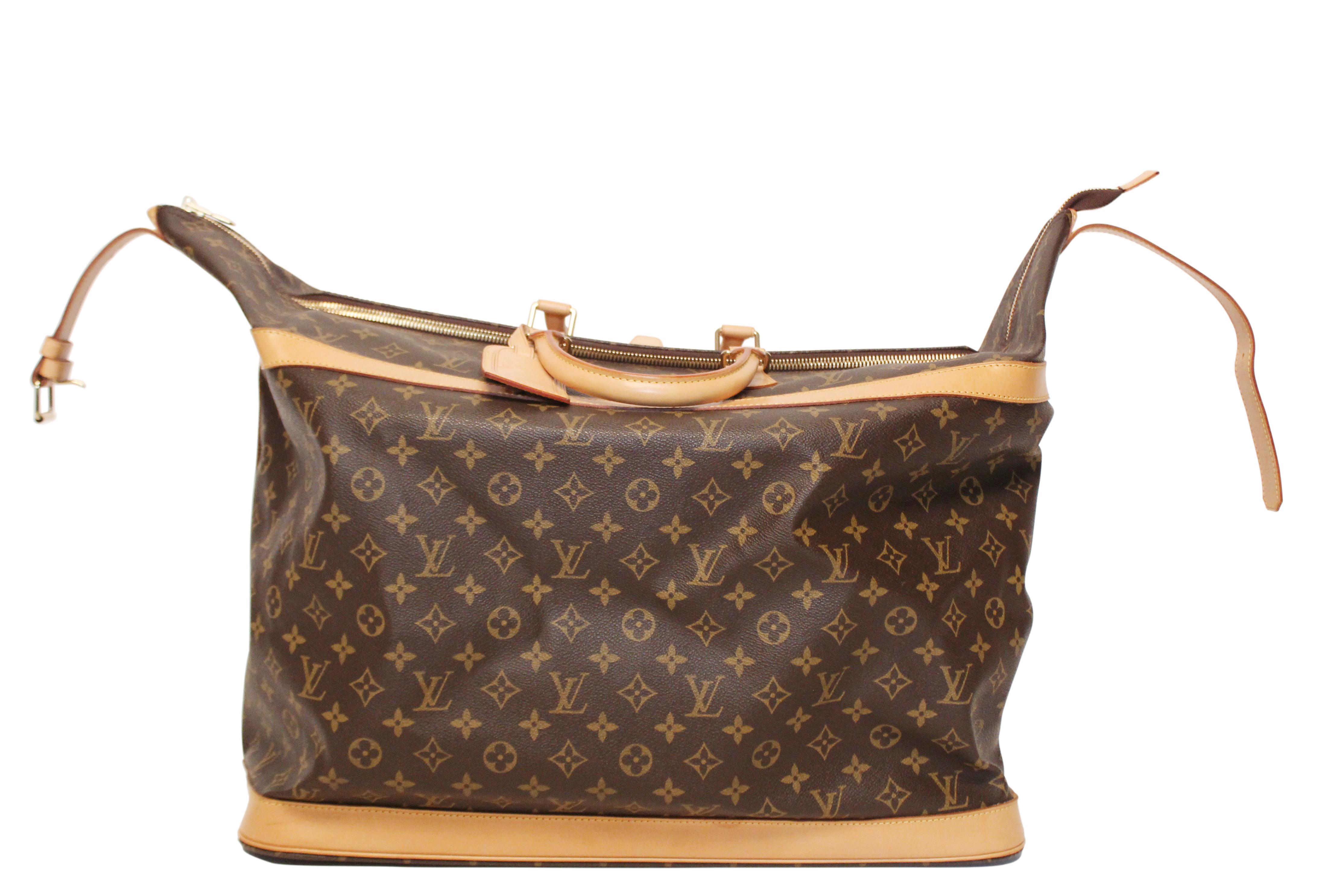 Louis Vuitton monogram vachetta leather and coated canvas Cruiser 50 travel bag with fabric interior. This spacious, light weight, hand held bag features leather top handles, top buckle with silver toned hardware and light tan leather trim
