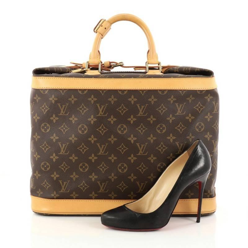 This authentic Louis Vuitton Cruiser Handbag Monogram Canvas 40 showcases the brand's timeless and luxurious style and functionality. Crafted in Louis Vuitton's iconic brown monogram coated canvas, this chic travel luggage features dual-rolled