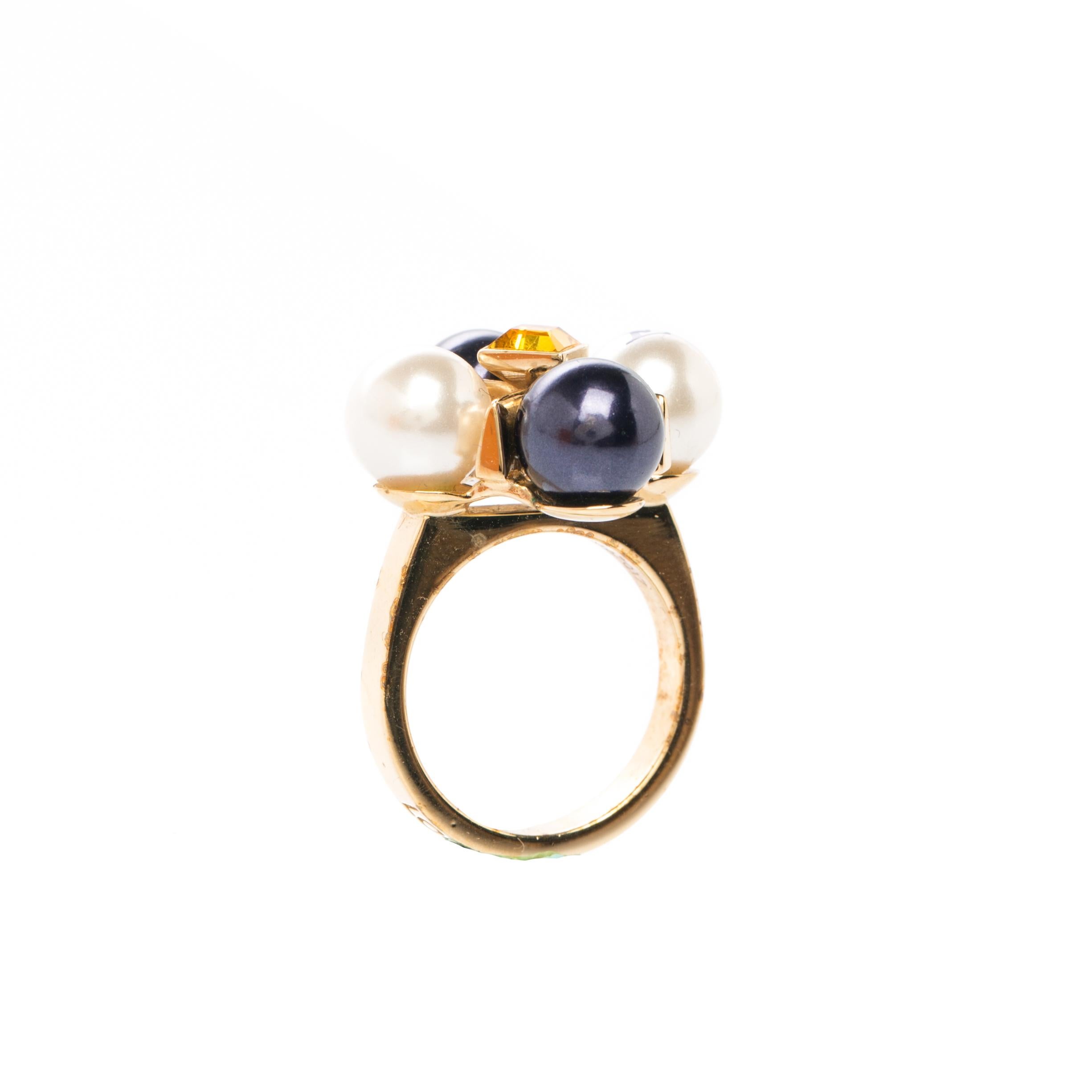 This cocktail ring addresses Louis Vuitton's signature elegance and timelessness. Made from gold-tone metal, the ring is gracefully accented with faux pearls and a crystal. The ring speaks style in a subtle way. LV admirers must have this ethereal