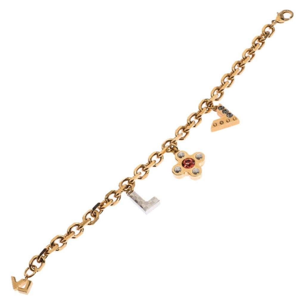 Simple yet elegant, this Louis Vuitton bracelet features a metal body detailed with three signature charms. The charms are detailed with crystals as well as studs and they beautifully dangle with every wrist movement. The bracelet can be fastened