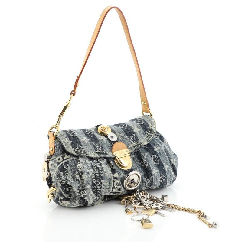This Louis Vuitton Custom Pleaty Raye Handbag Limited Edition Denim Mini, crafted from blue monogram denim, features a detachable vachetta leather strap, subtle pleats, and gold and silver-tone hardware. Its push-lock closure opens to a yellow