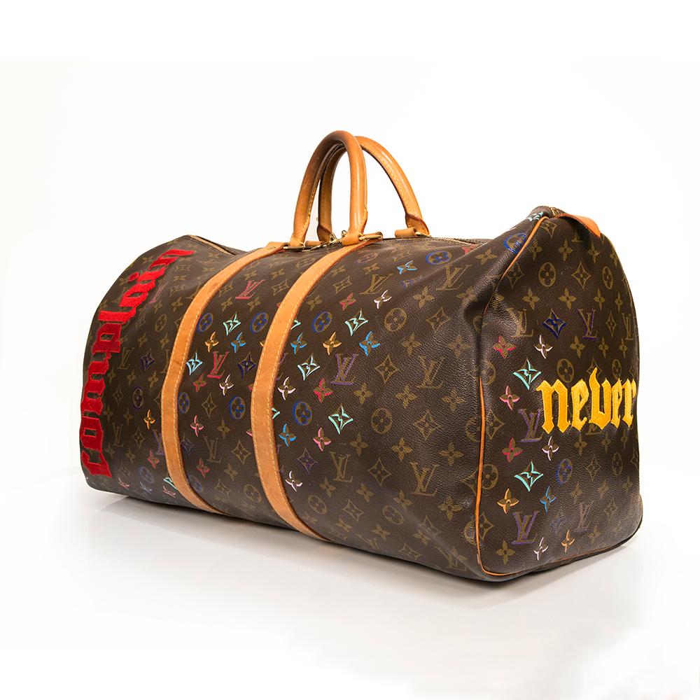 This hand-painted and meticulously embroidered Louis Vuitton 'Never Complain, Never Explain' Keepall 45 bag from Rewind's Emotional Baggage collection, where iconic handbags are specially customized with hand-painted illustrations, is perfect for