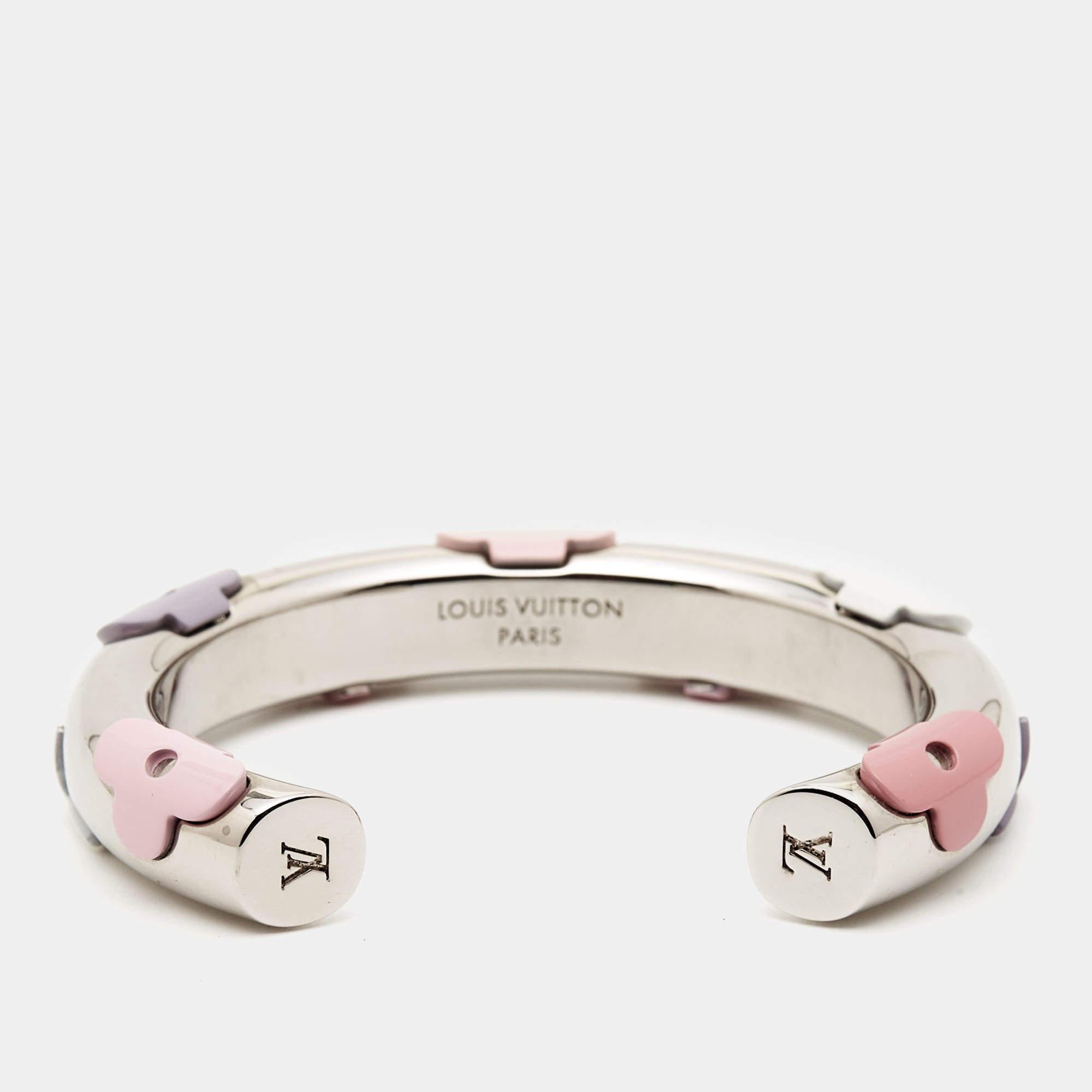 The Louis Vuitton bracelet exudes sophistication with its iconic monogram pattern made from resin. The silver-tone metal cuff showcases meticulous craftsmanship, seamlessly blending luxury and contemporary style. This accessory is a statement piece,