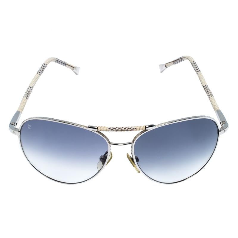 These gorgeous Louis Vuitton Conspiration Pilote aviators are made from silver-tone metal. The temples and top bar are covered with Damier Azur pattern for a signature finish. The shaded lenses make the pair complete.

Includes: Original Pouch,