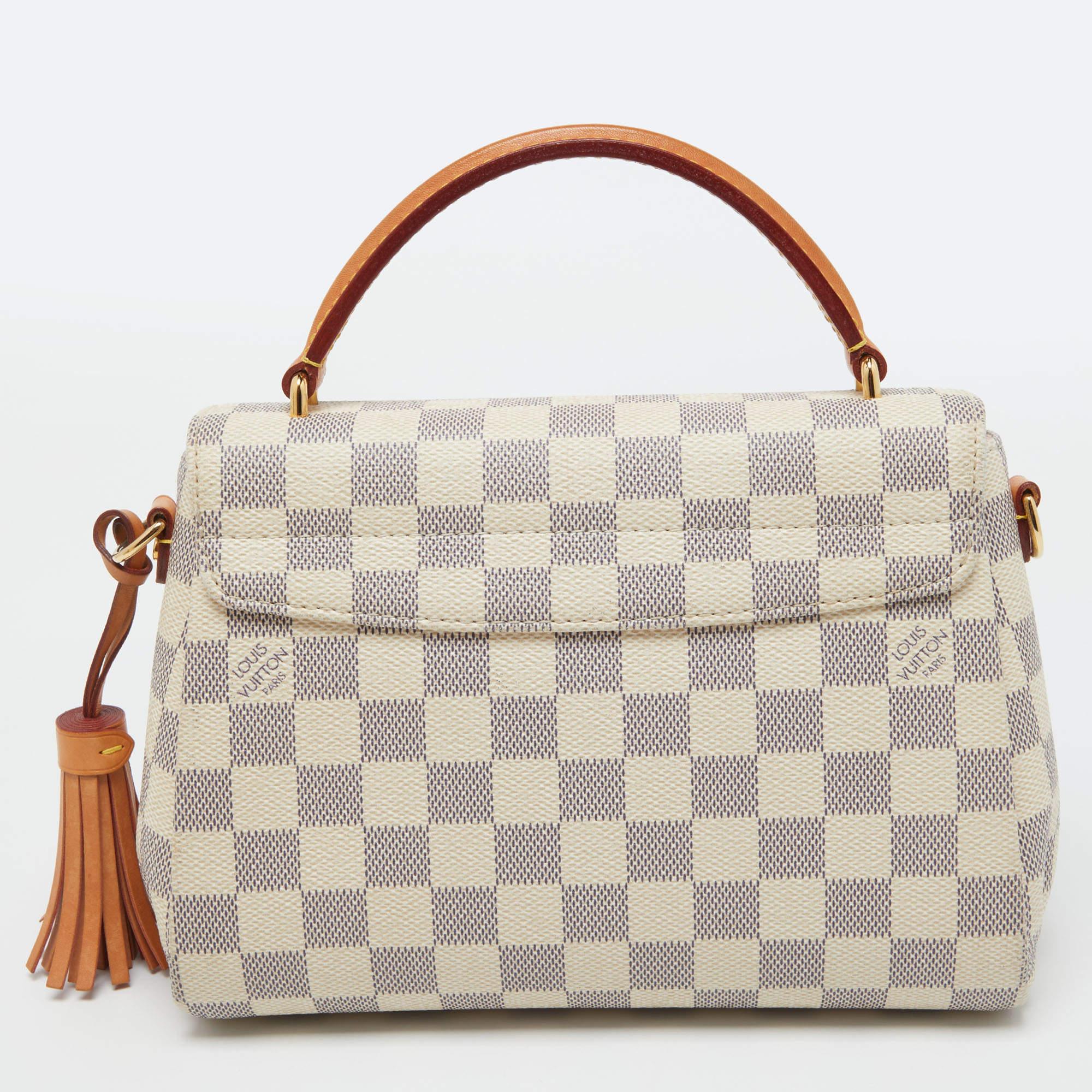 Treat yourself to this Croisette bag by Louis Vuitton. This structured style is crafted from signature Damier Azur canvas. It has a logo-engraved lock in gold-tone hardware, a top handle, and a slender shoulder strap for crossbody wear. The