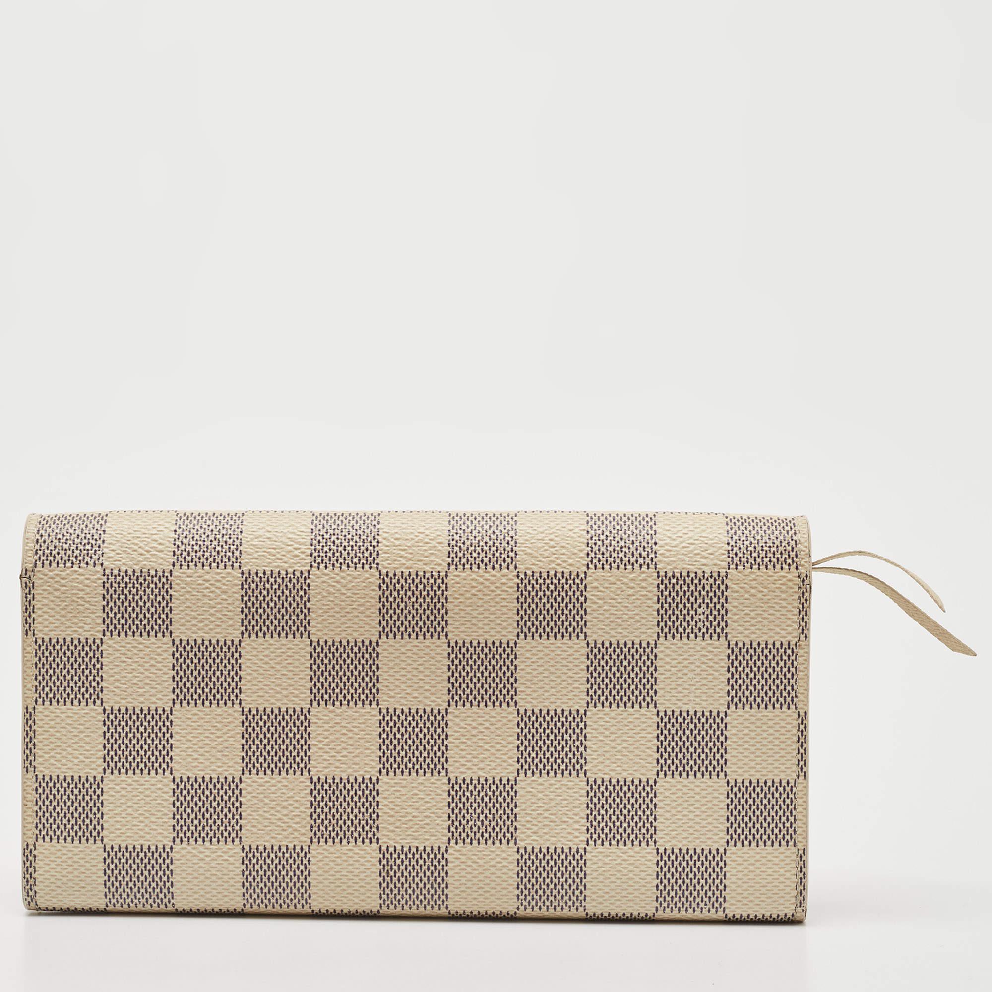 Proving that functionality and beautiful design can exist together, the Emilie wallet is elegant and perfect for daily use. Made from Damier Azur canvas, it comes with a zipper compartment and press-stud closure. Slide it into your tote or carry it