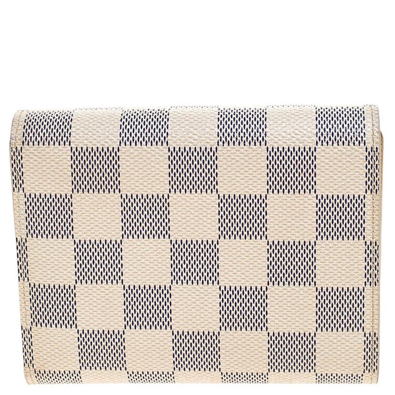 This Joey wallet from Louis Vuitton is not only good looking but also functional. Crafted from signature Damier Azur canvas this number flaunts a logo engraved push lock closure. The interior has card slots, an ID slot and a zip pocket for you to
