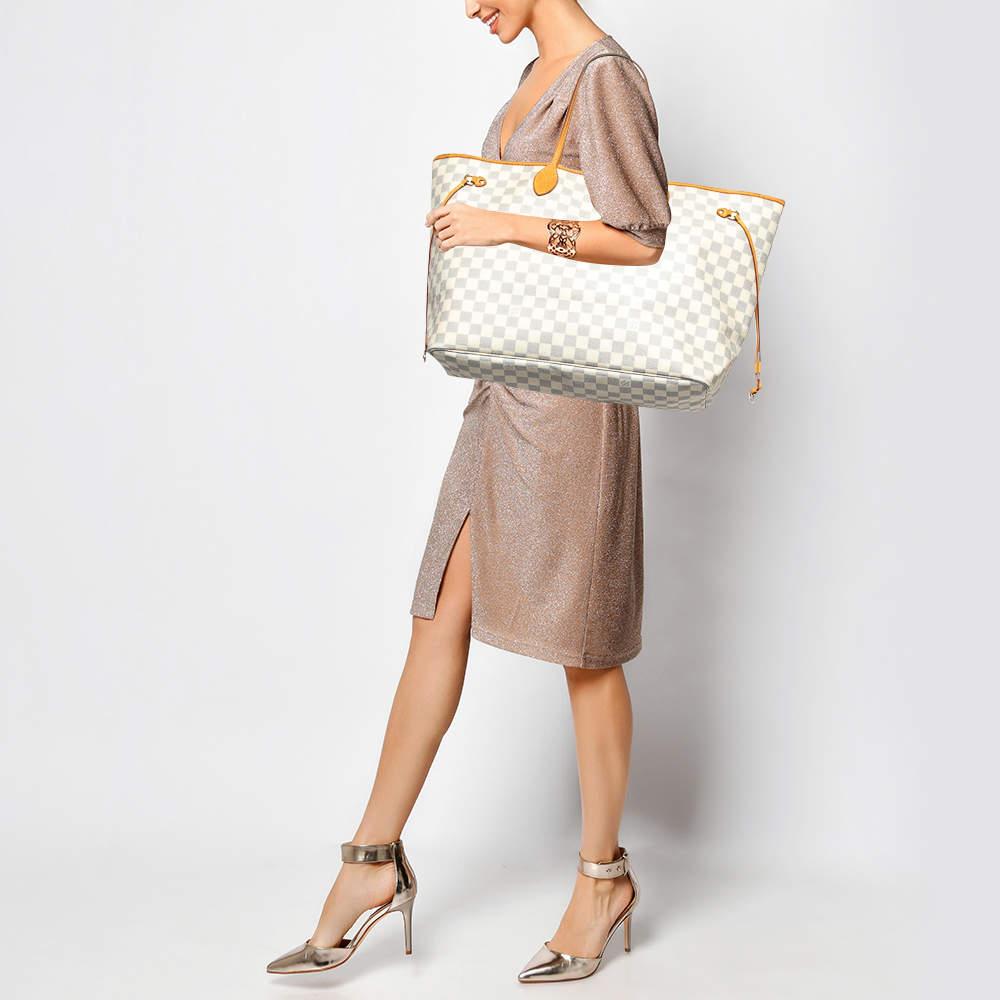 Louis Vuittonâ€™s Neverfull was first introduced in 2007  and even today it is a popular design. Crafted from Damier Azur canvas  this Neverfull is gorgeous. The bag has drawstrings on the sides  a spacious canvas interior that can house all your