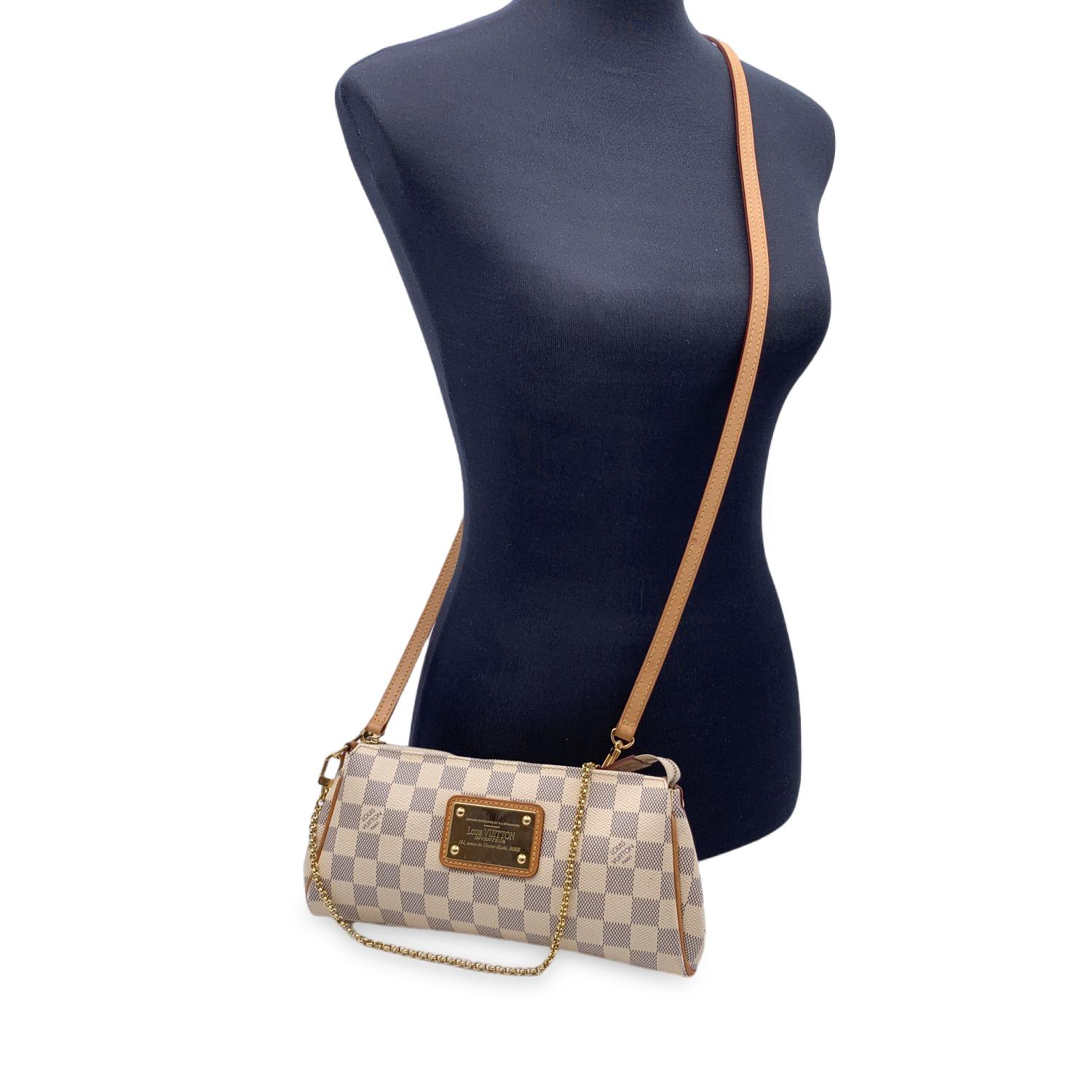 Louis Vuitton Pochette 'Eva' in Damier Azur canvas. Gold metal 'Louis Vuitton Inventeur' logo plaque on the front. Upper zipper closure. Fabric lining. It has a chain shoulder strap and a longer leather one, so can be worn both over the shoulder and