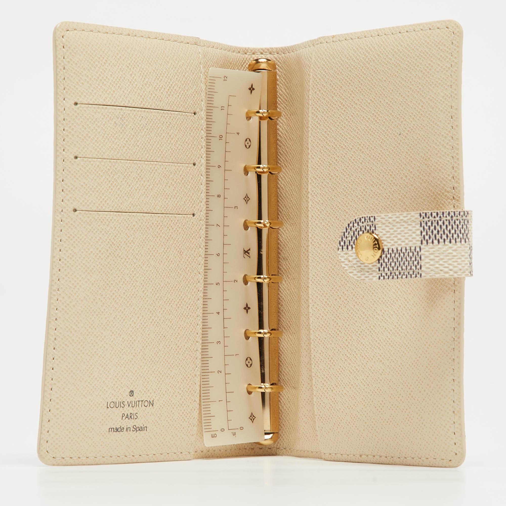 Functional creations like this one from Louis Vuitton are totally worth the splurge. This Agenda Cover has a Damier Azur coated canvas exterior designed in a bifold style with slots and a measuring scale inside.