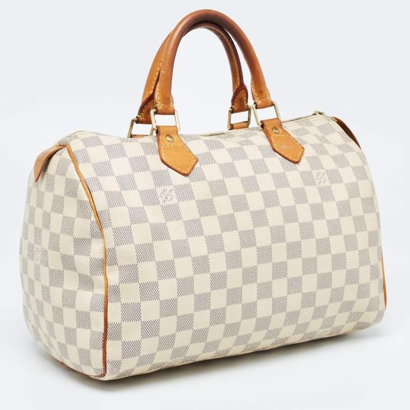 Created to provide you with everyday ease, this Louis Vuitton Speedy 30 bag features dual top handles and a roomy canvas-lined interior. The usage of the signature Damier Azur canvas in its construction offers instant brand identification. Gold-tone