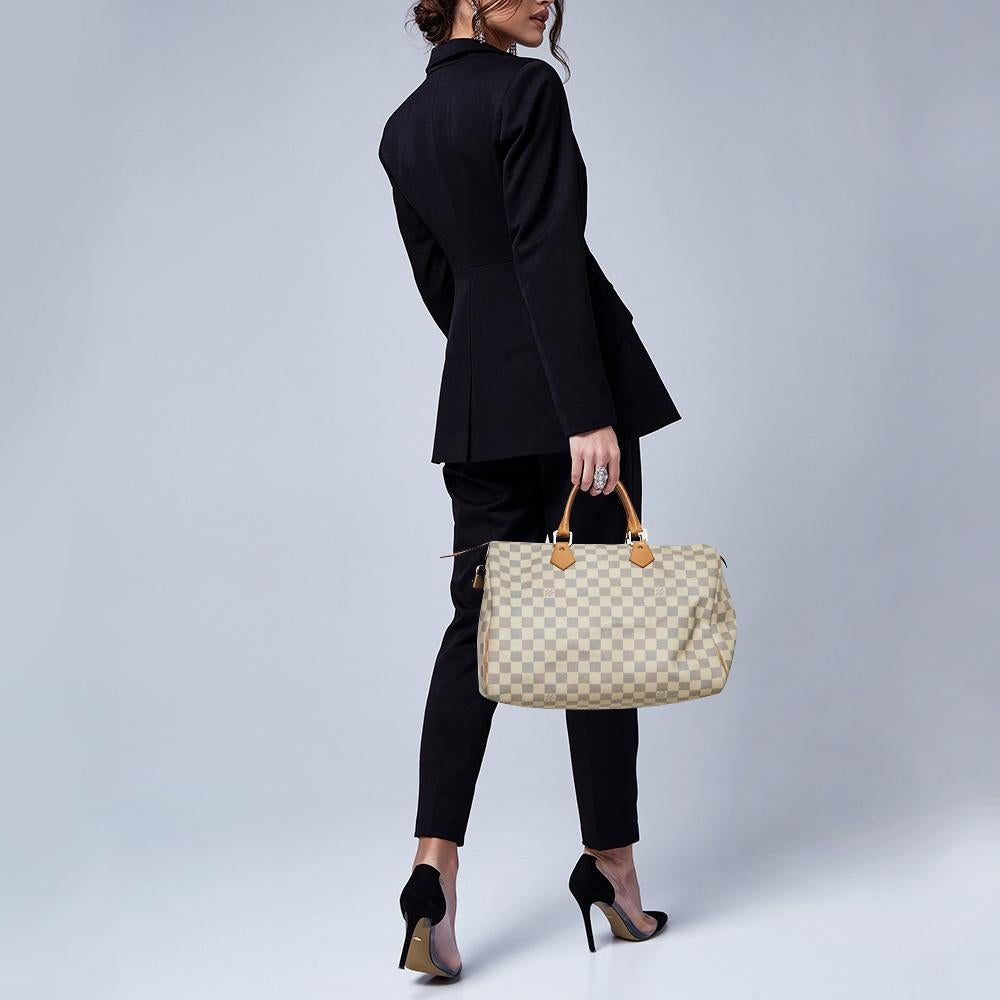 Titled as one of the greatest handbags in the history of luxury fashion, the Speedy from Louis Vuitton was first created for everyday use as a smaller version of their famous Keepall bag. This Speedy comes crafted from Damier Azur canvas and leather