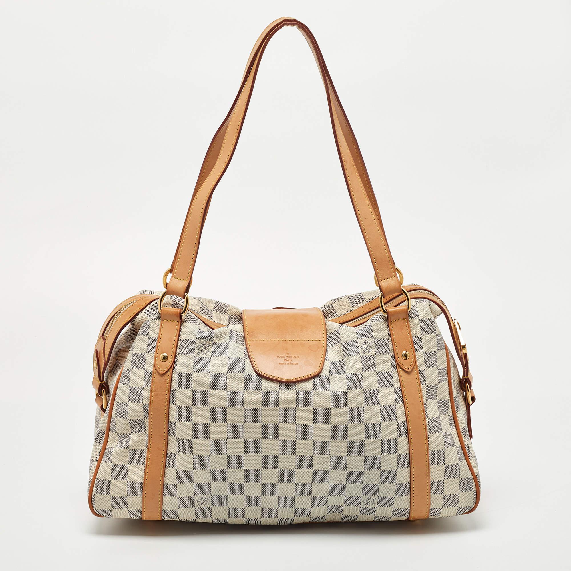 This Stresa bag by Louis Vuitton will add ease to your daily routine. Crafted from Damier Azur canvas with leather trims, it features a top zipper closure, dual handles, and polished gold-tone hardware. The canvas-lined interior has ample space for