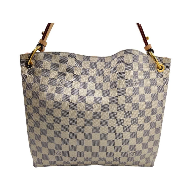 We are offering this beautiful Louis Vuitton Monogram Graceful PM. Made in France in 2018, this bag is crafted of the blue & white Louis Vuitton Damier Azur coated canvas exterior with a flat vachetta leather shoulder strap and brass hardware. It