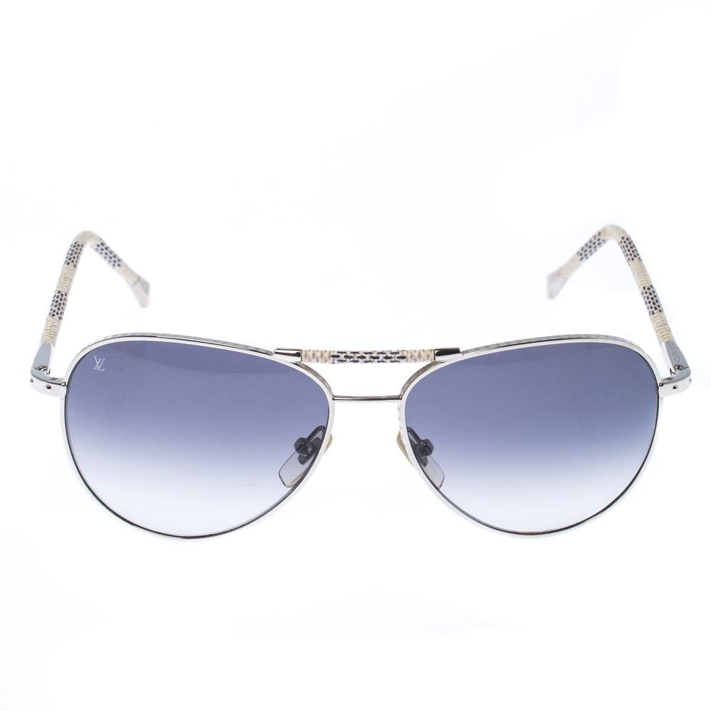 These gorgeous Louis Vuitton Conspiration Pilote aviators are made from silver-tone metal. The temples and top bar are covered with Damier Azur pattern for a signature finish. The grey gradient lenses offer 100% UV protection.

Includes: The Luxury