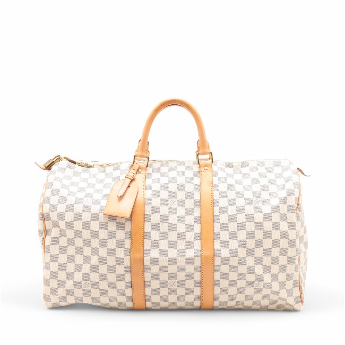 The Louis Vuitton Damier Azur Keepall 50 is a stylish and practical travel bag, featuring the signature white and blue checked Damier Azur canvas. Ideal for weekend getaways, its spacious interior offers ample room for all your essentials. Accented