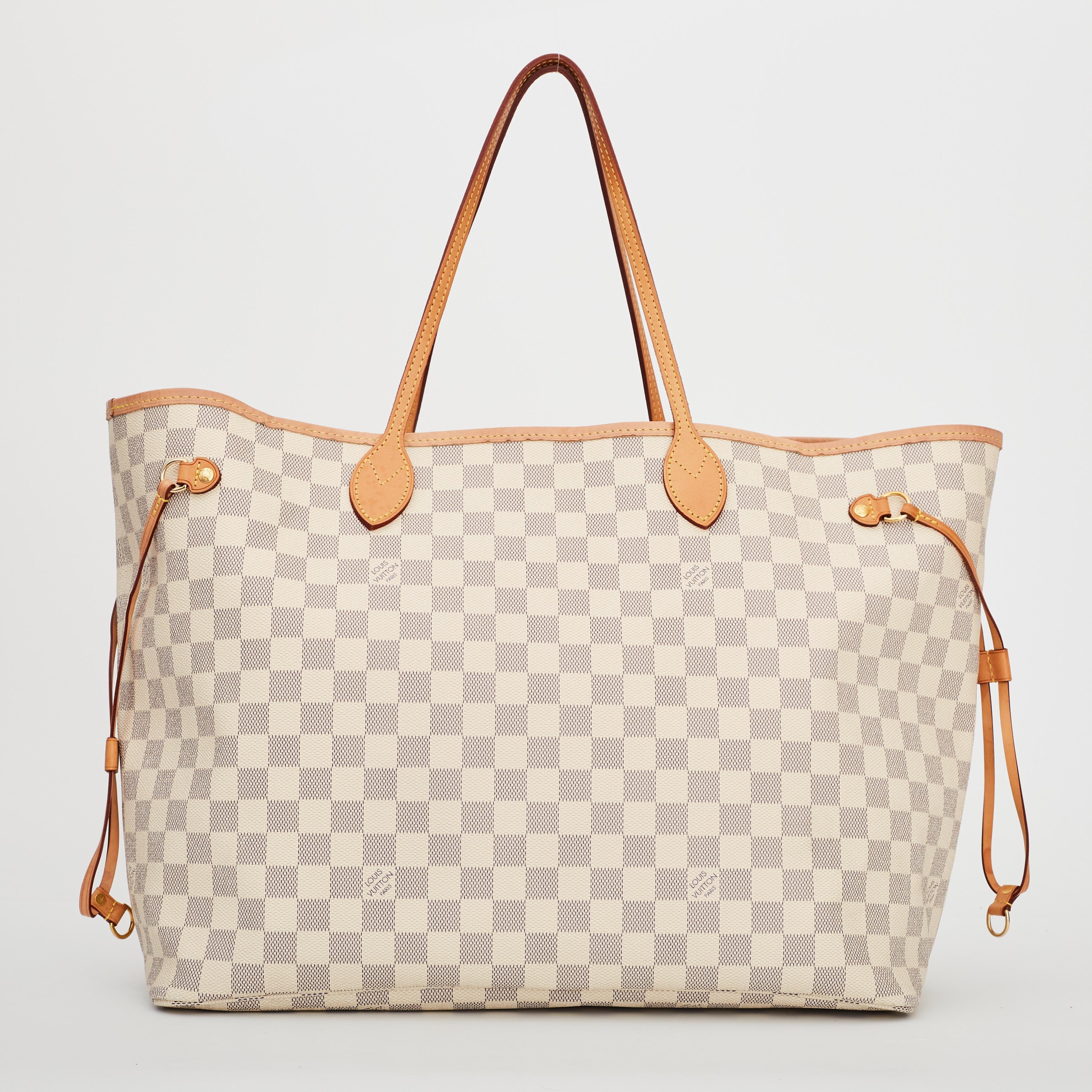 This tote is made of Louis Vuitton signature damier canvas in light azure blue in the medium size. The bag features vachetta cowhide leather strap handles, trim and side cinch cords with polished brass hardware. The top is wide and open to a striped