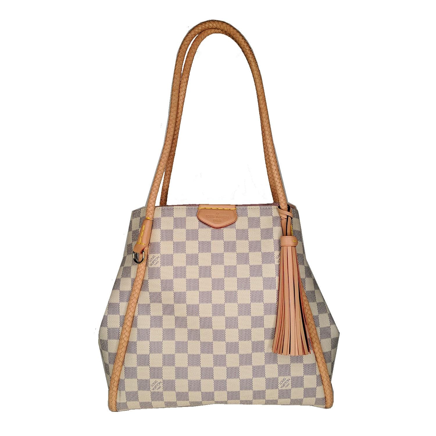 This surprisingly refined shoulder tote with its delicate braided leather piping and handles, soft rose-colored lining, and playful leather tassel is all about summer elegance. As versatile as it is chic, it’s perfect for the city and the beach.