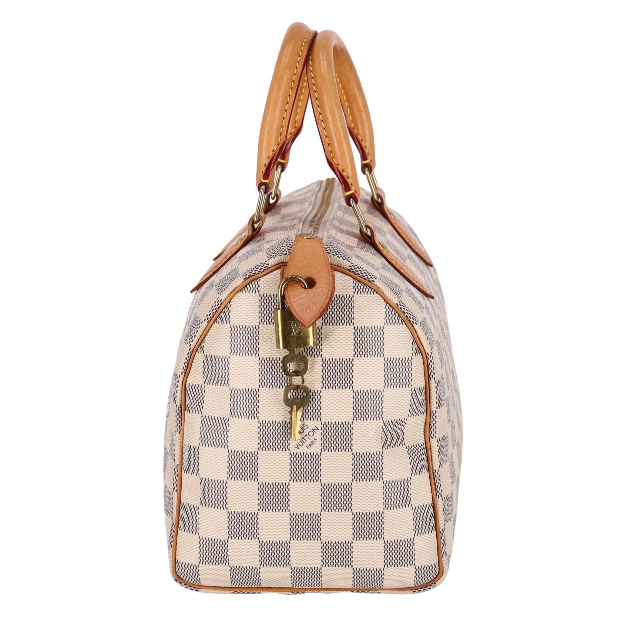 Louis Vuitton Damier Azur Speedy 25 Handbag

White and grey bag crafted in signature Damier coated canvas.

Detailed with beige leather details and dual rolled top handle.

Having gold branded hardware, padlock and keys.

Size – Height 19cm, Width