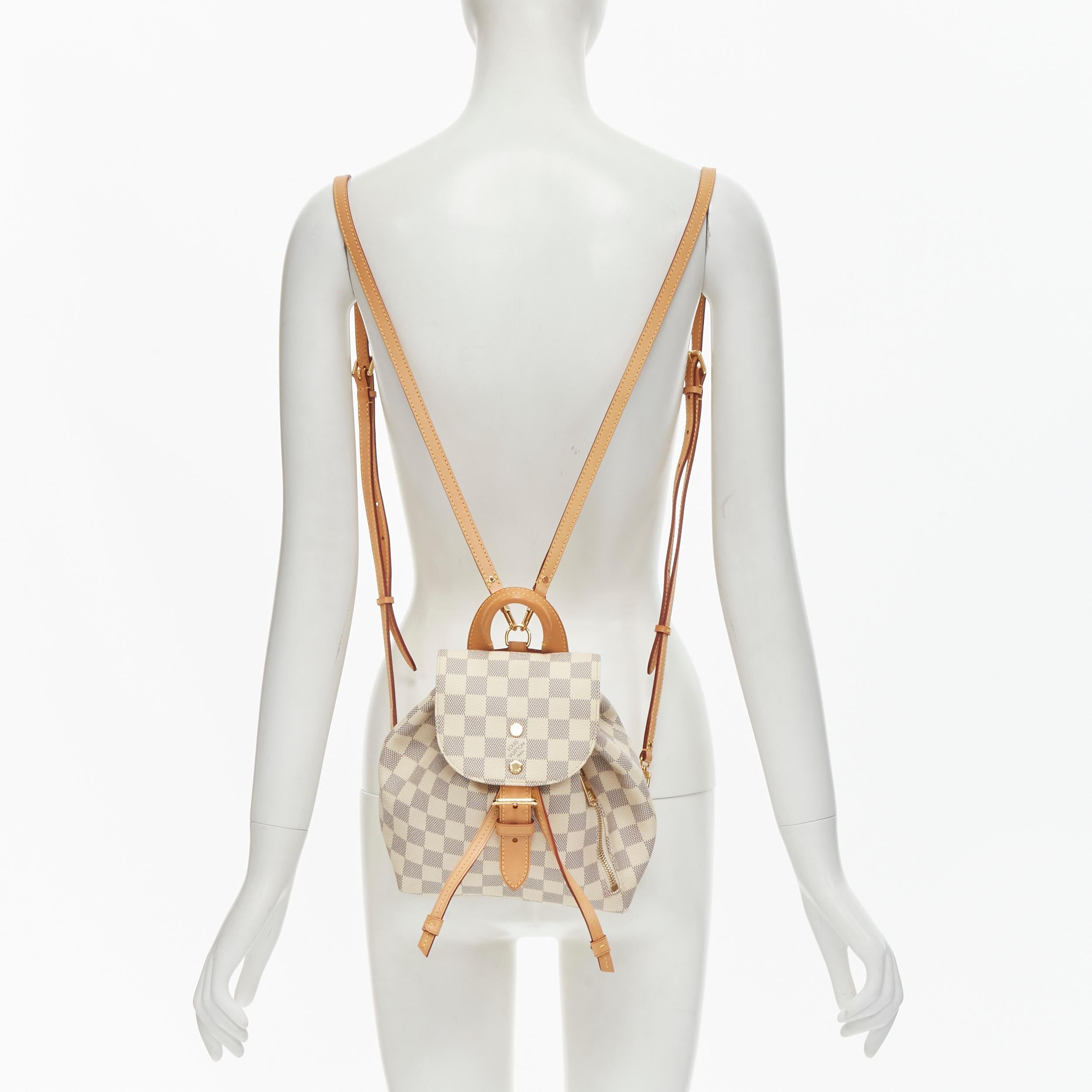 LOUIS VUITTON Damier Azur Sperone BB white checked backpack 
Reference: CECU/A00001 
Brand: Louis Vuitton 
Model: Damier Azur Sperone BB 
Collection: 2020 
Material: Canvas 
Color: White 
Pattern: Checked 
Closure: Drawstring 
Extra Detail: From