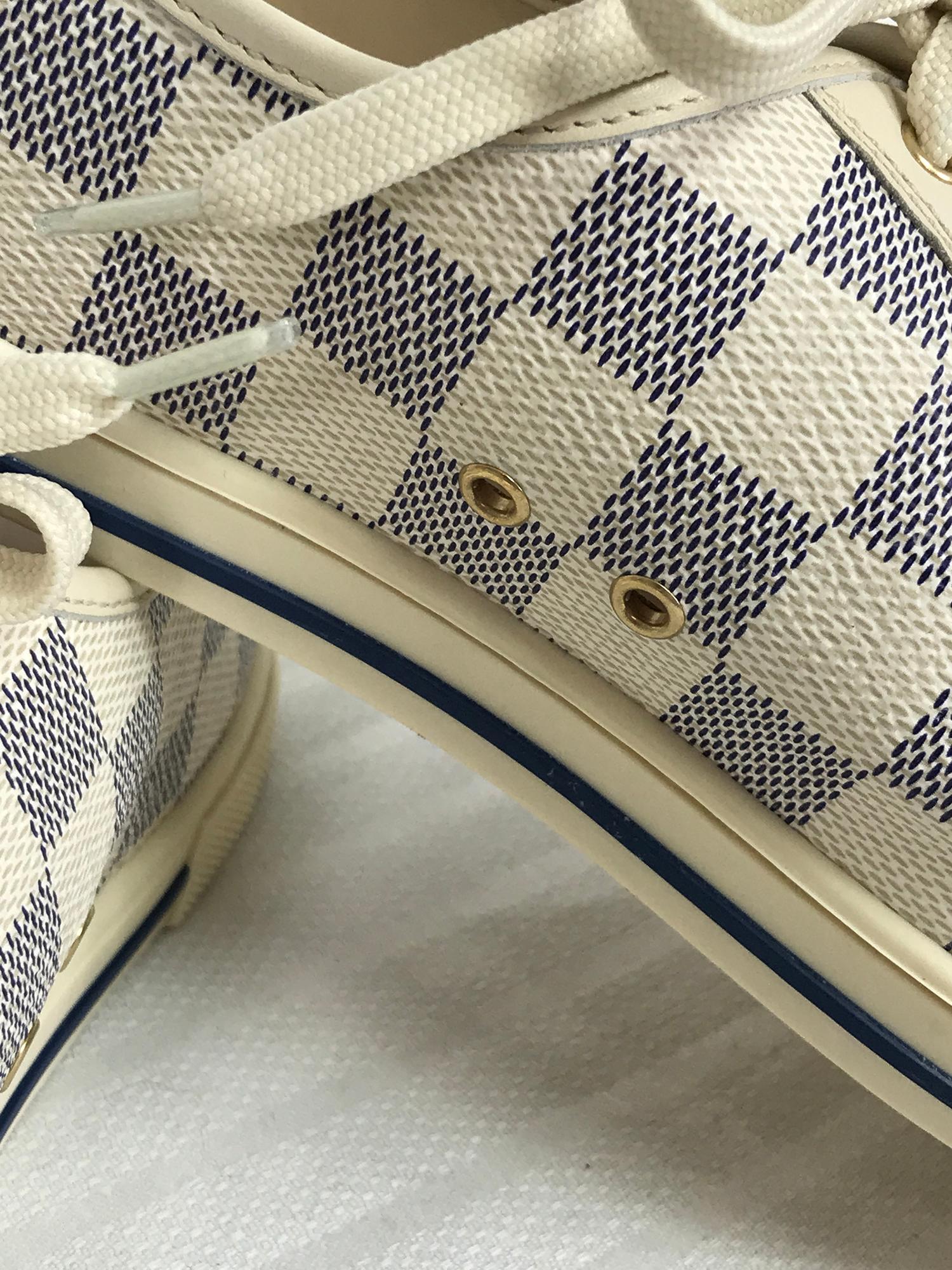 Louis Vuitton womens Damier Azur canvas and cream leather sneakers with gold hardware, marked 8 1/2. Logo canvas with toe caps of cream leather. The shoes are lined in soft cream leather. Gold metal grommets. In very good condition.