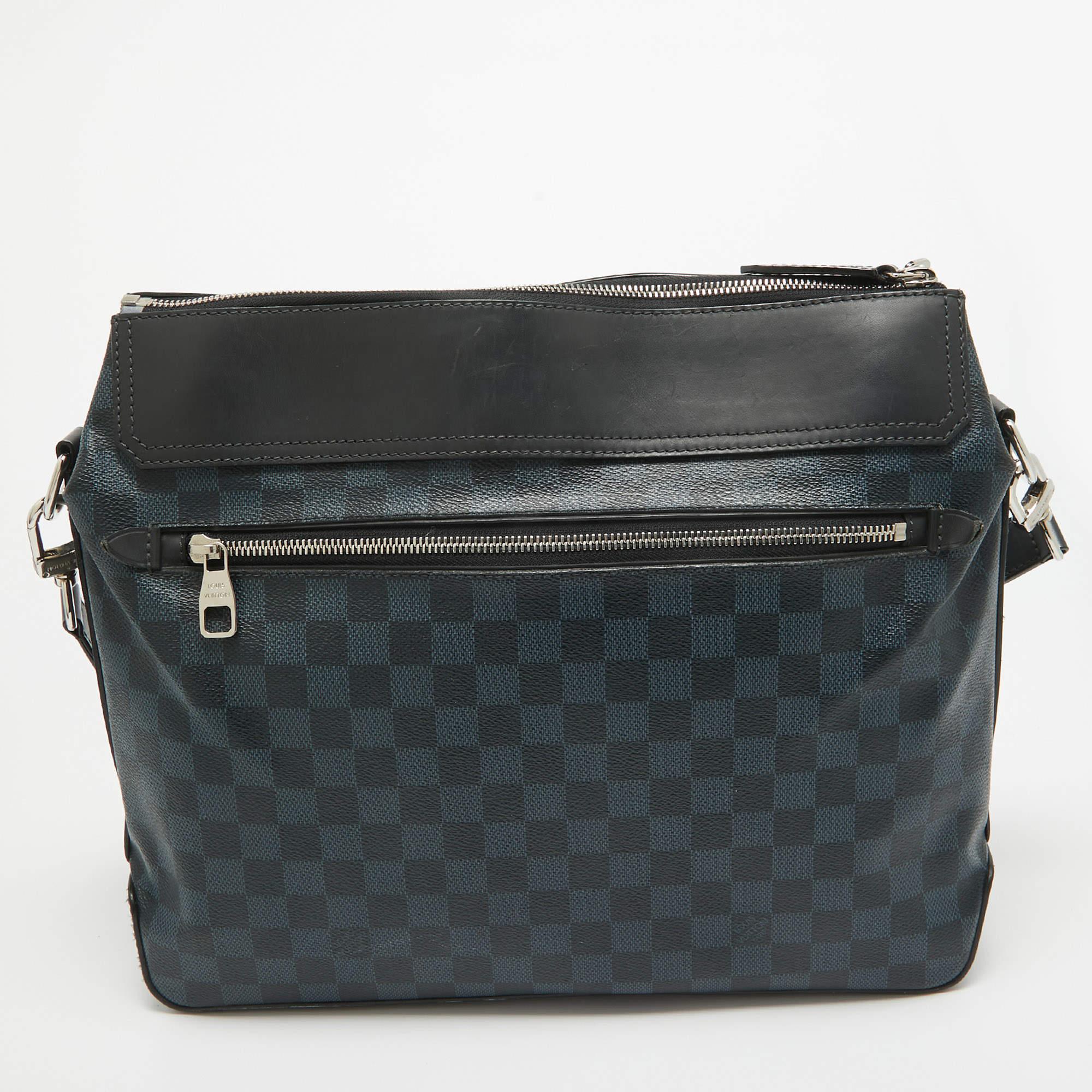 This messenger bag from Louis Vuitton comes loaded with excellent style and craftsmanship. The bag has been crafted from Damier Cobalt canvas and designed with a top zipper which secures an Alcantara interior sized to carry your belongings. It is