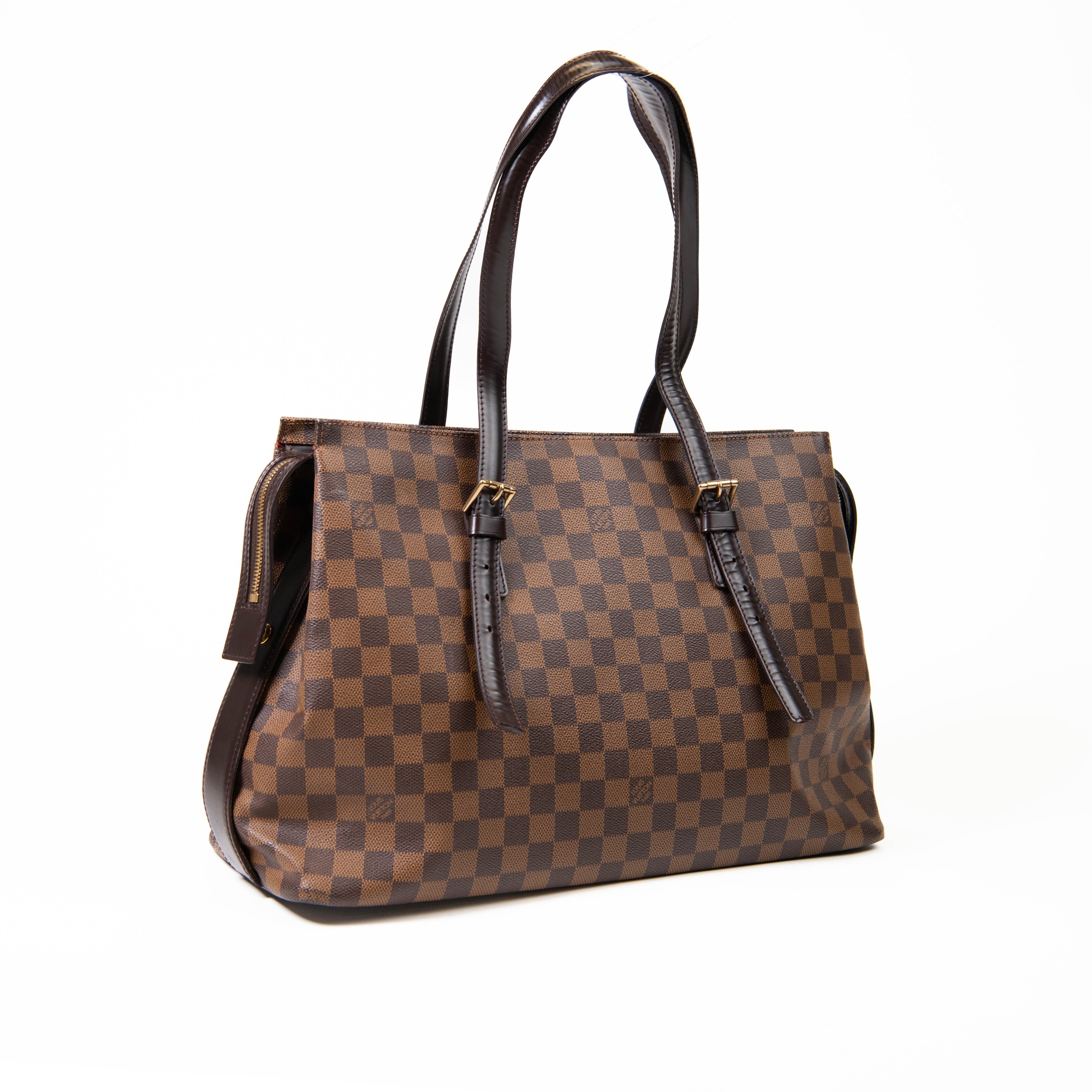 100% Authentic 
Louis Vuitton Damier Ebene Brown Canvas Chelsea Tote

This sophisticated tote is finely crafted of Louis Vuitton's signature checked Damier canvas in ebene brown. The bag features adjustable dark brown leather handles, base, trim and