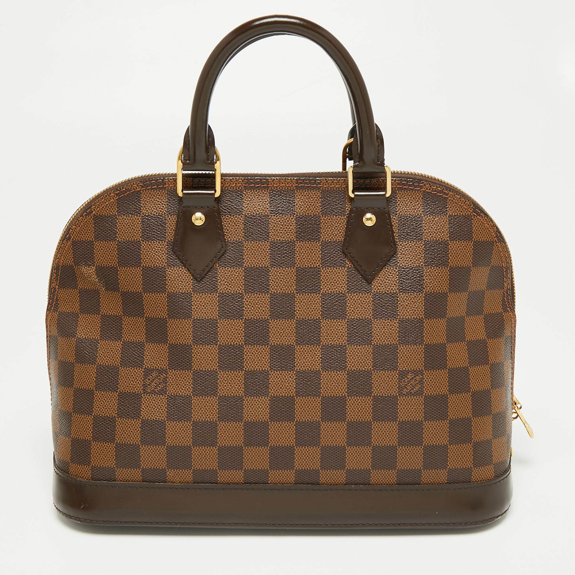 Out of all the irresistible handbags from Louis Vuitton, the Alma is the most structured one. First introduced in 1934 by Gaston-Louis Vuitton, the Alma is a classic that has received love from icons. This piece comes crafted from Damier Ebene and