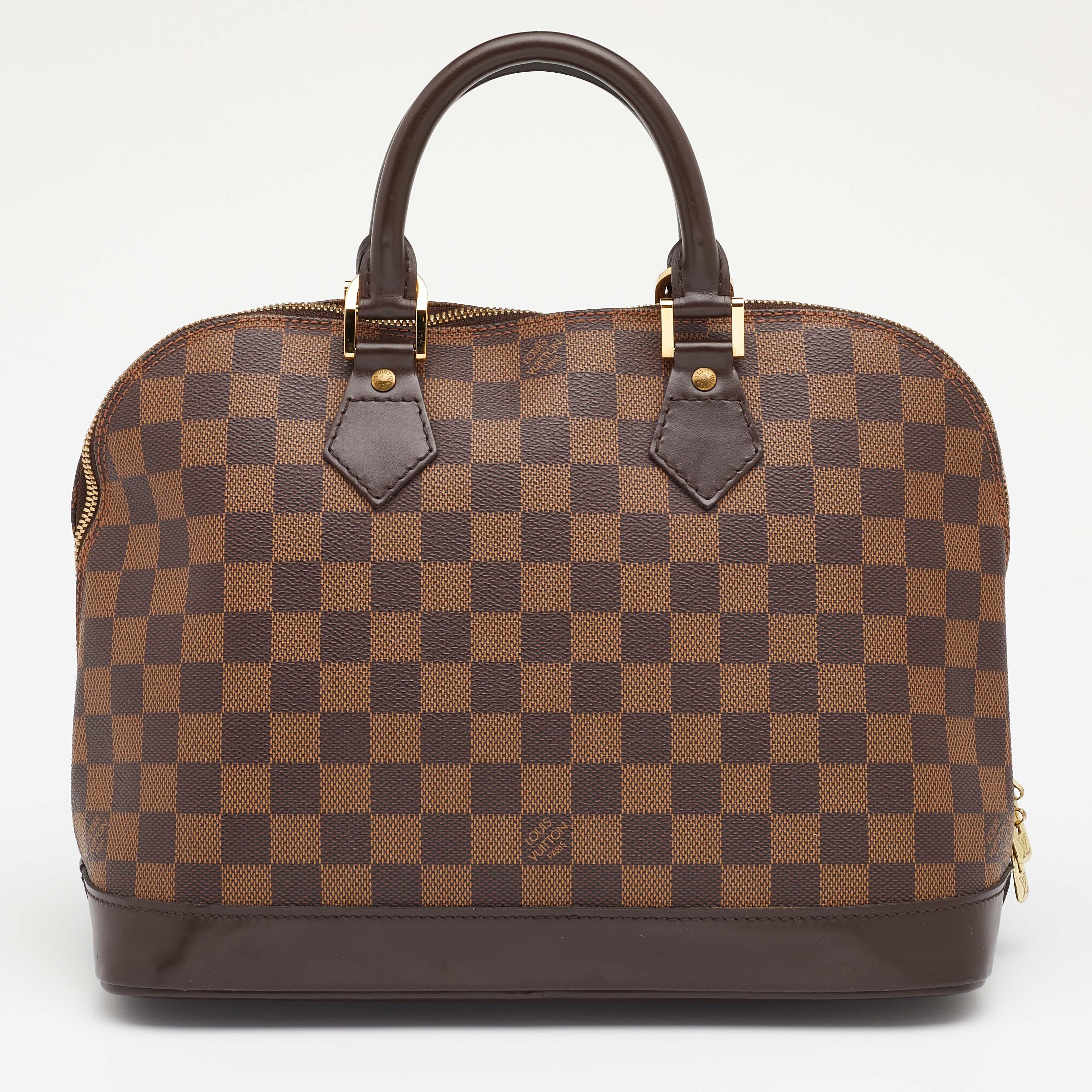 Out of all the irresistible handbags from Louis Vuitton, the Alma is the most structured one. First introduced in 1934 by Gaston-Louis Vuitton, the Alma is a classic that has received love from icons. This piece comes crafted from Damier Ebene