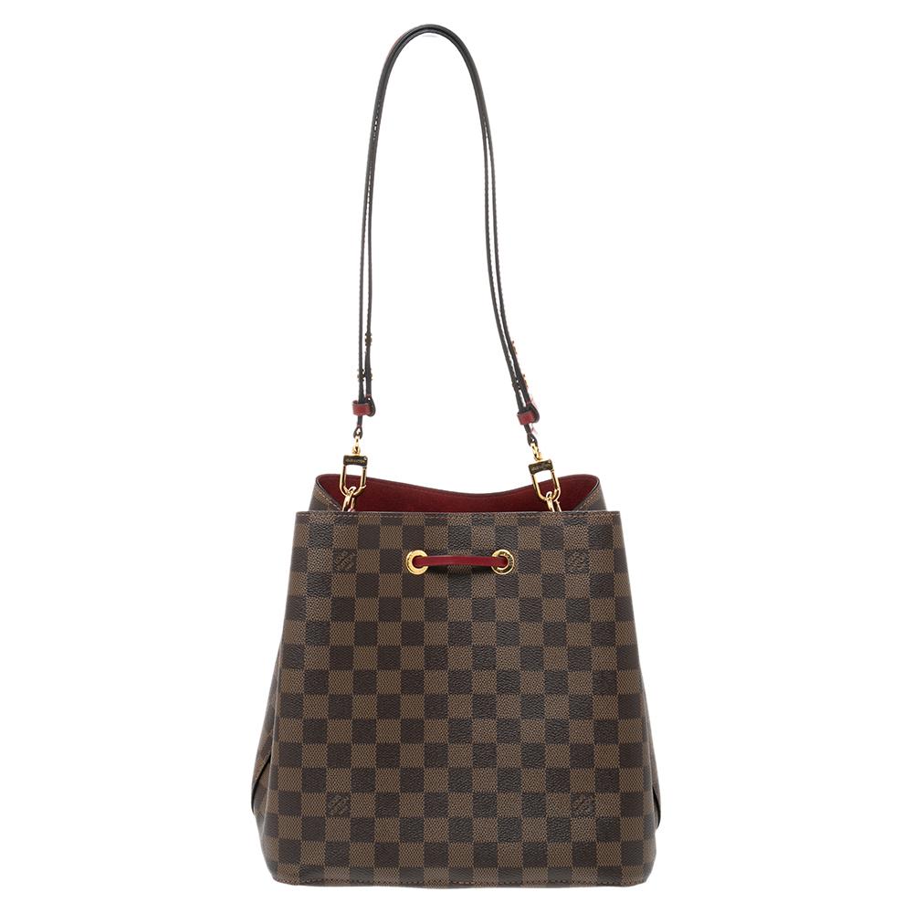 Louis Vuitton's NéoNoé bag was made to carry Champagne bottles in style; this contemporary iteration is crafted from Damier Ebene canvas and features a sleek yet malleable shape, contrasting leather trim, and an Alcantara interior. The adjustable