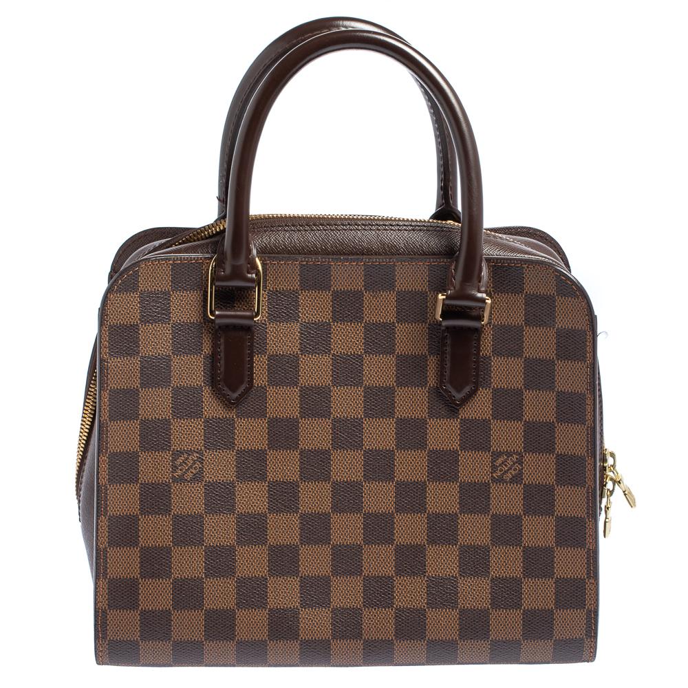 This Louis Vuitton Triana bag is perfect for everyday use! Effortlessly elegant, this bag is crafted from signature Damier Ebene canvas as well as leather and features double top handles, gold-tone hardware, and a top zip closure. Lined with