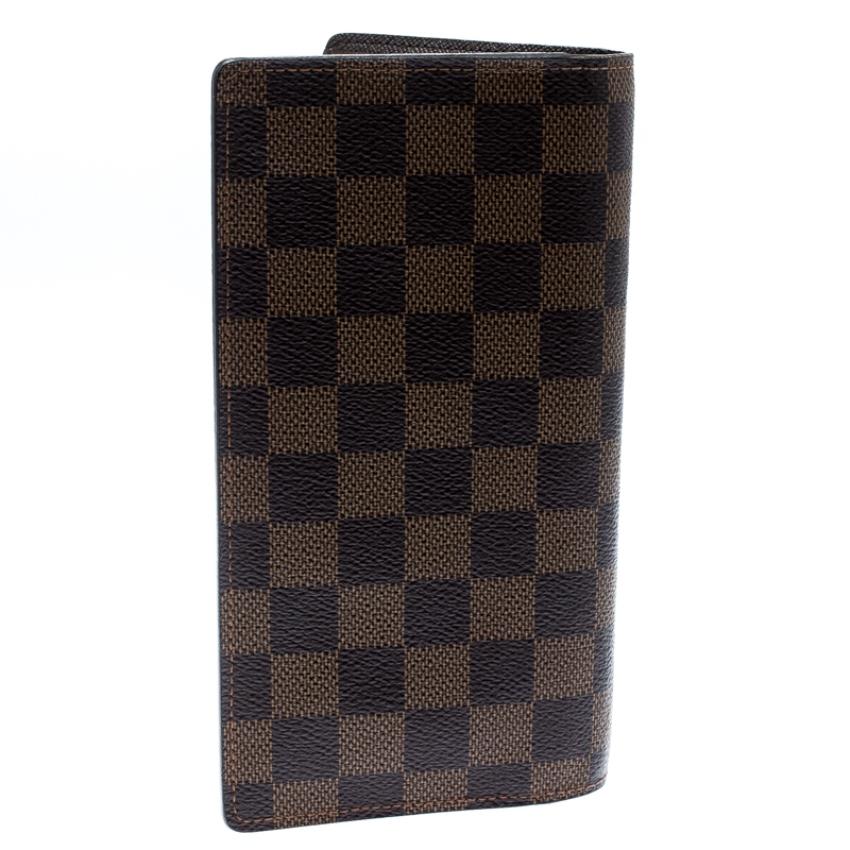 Carry the best accessories by choosing designs such as this wallet by Louis Vuitton. The elegant and stylish wallet is bi-fold and is made from Damier Ebene canvas, thus lending a luxe touch to the plain design. The wallet has multiple card slots