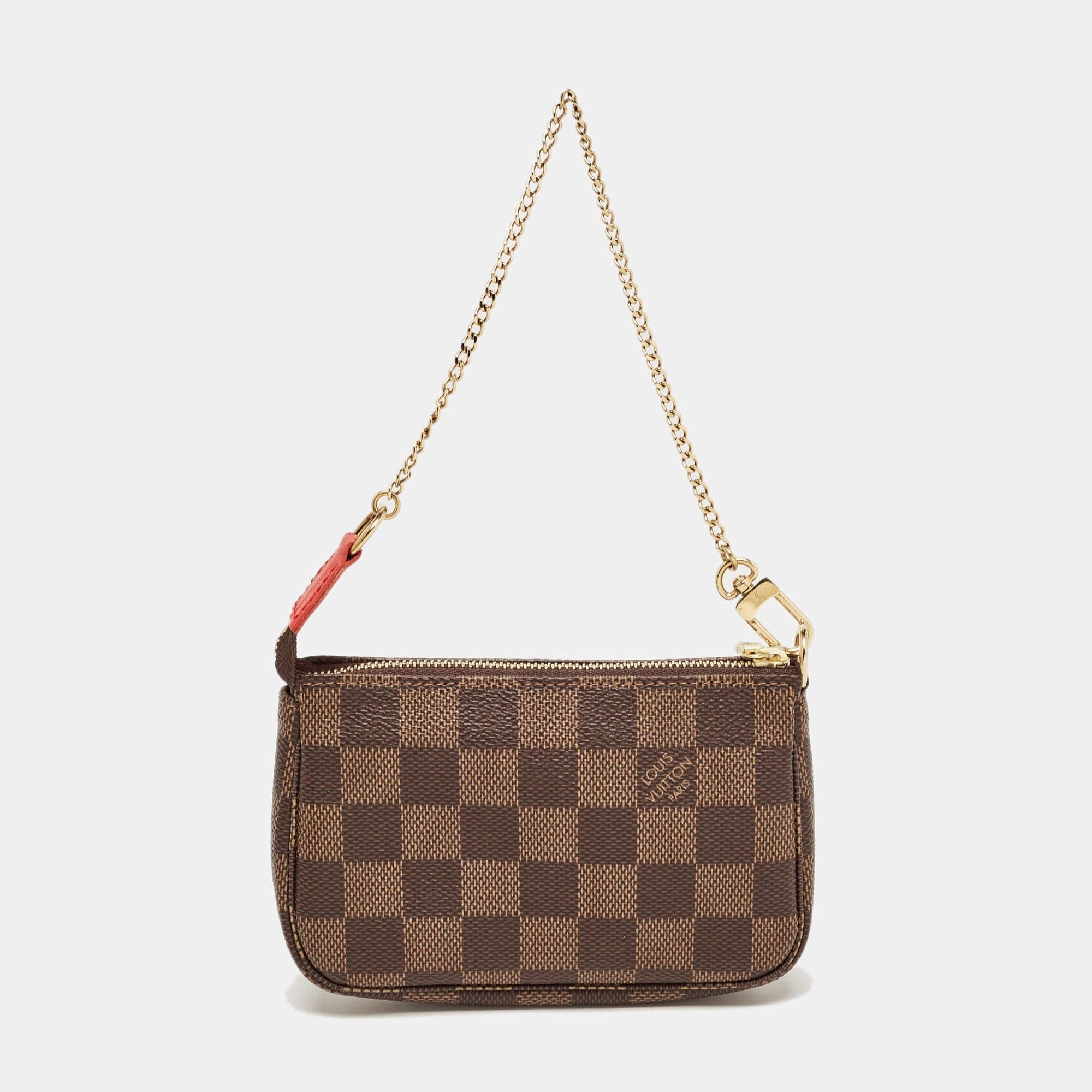 This Louis Vuitton mini Vivienne Pochette Accessoires is a special edition. It is crafted from monogram canvas and the zip on top opens to a canvas-lined interior. Perfect in size, this bag is held by a gold-tone chain.

Includes: Original Dustbag

