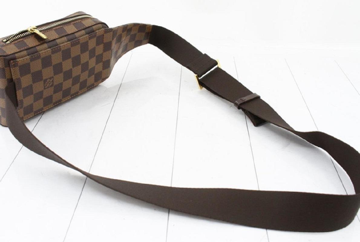 Brown Damier Ebene coated canvas Louis Vuitton Geronimos waist bag with gold-tone hardware, single adjustable waist strap with buckle closure, single pocket at exterior with snap closure, brown canvas lining and zip around closure.


69275MSC