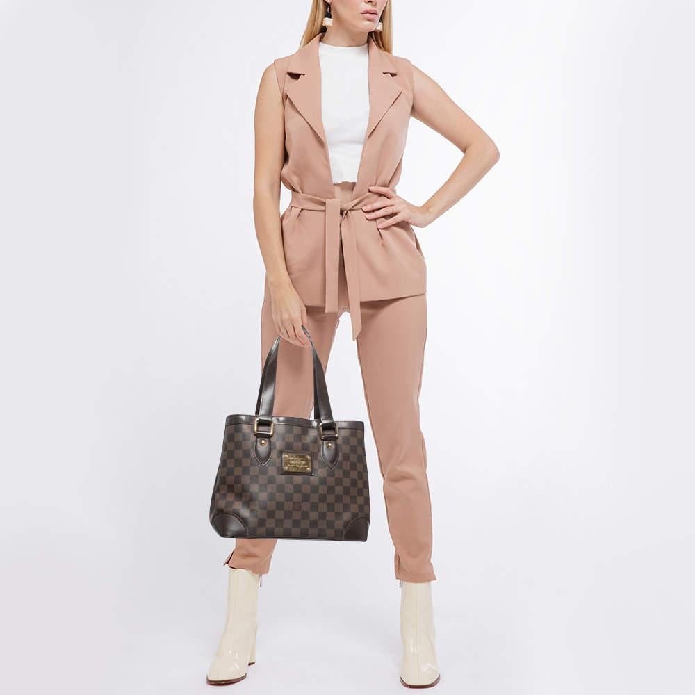 Louis Vuitton created the Damier canvas pattern in 1888, and has become the brand’s trademark ever since. Named after the London suburb, this Hampstead PM tote bag features leather top handles, reinforced base corners, and gleaming hardware. The