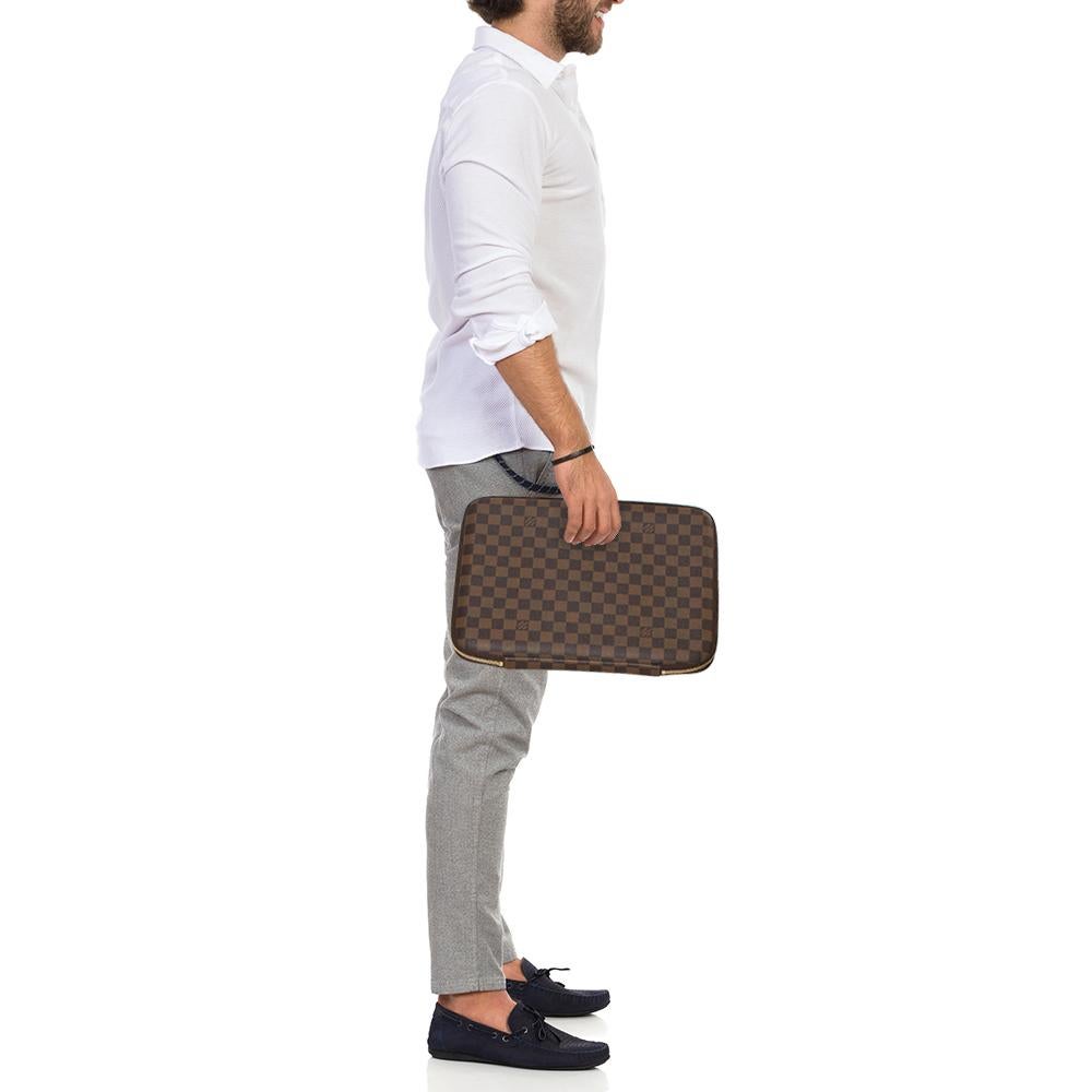 This Louis Vuitton laptop sleeve is built for making a statement. Crafted from the signature Damier Ebene canvas, it has a zip-around closure with dual zippers and opens to an Alcantara-lined interior that keeps your laptop safe from damage. It will
