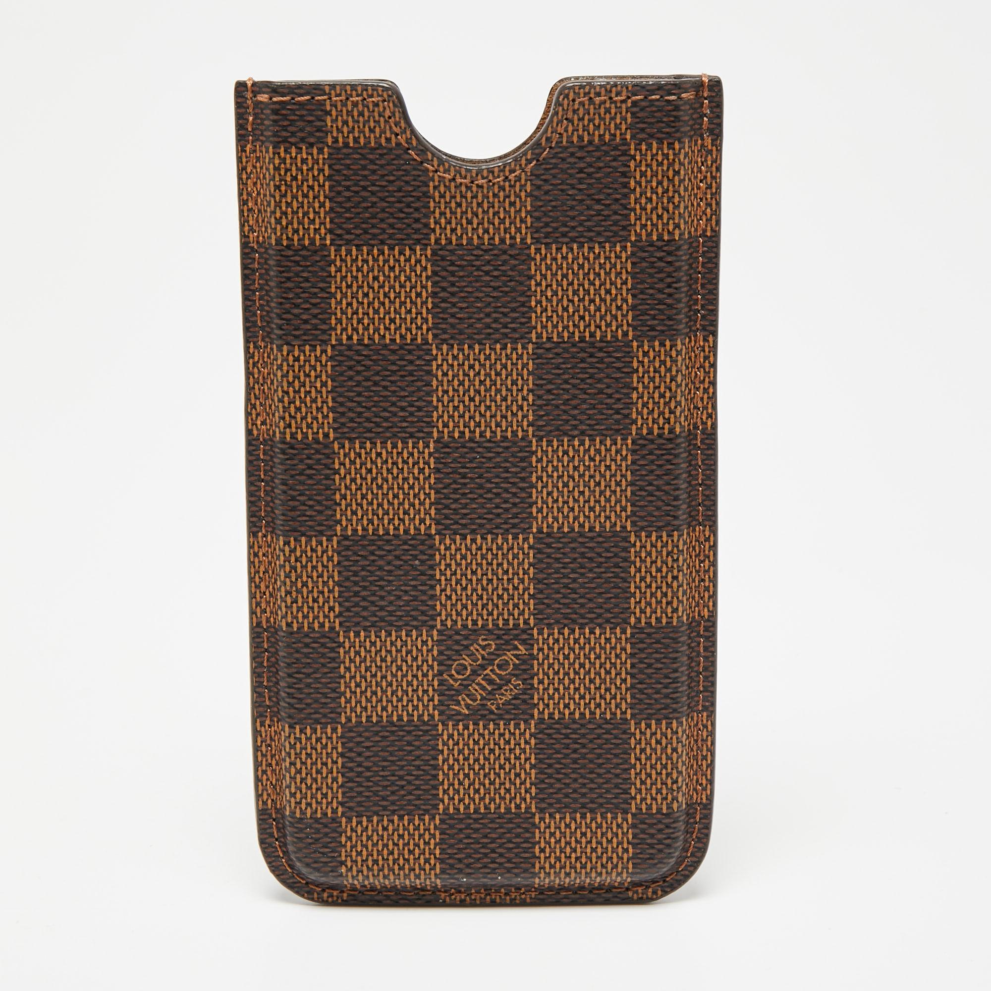 What's not to love about items that are both functional and worthy to be flaunted! This lovely Louis Vuitton cover has been designed smartly to safeguard your phone from any bumps, scratches, and dust. Made from Damier Ebene canvas, the case will