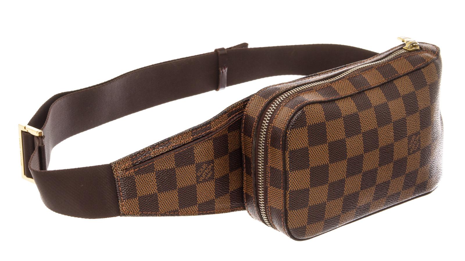 Brown Damier Ebene coated canvas Louis Vuitton Geronimos waist bag with gold-tone hardware, single adjustable waist strap with buckle closure, single pocket at exterior with snap closure, brown canvas lining and zip around closure.

 

67366MSC