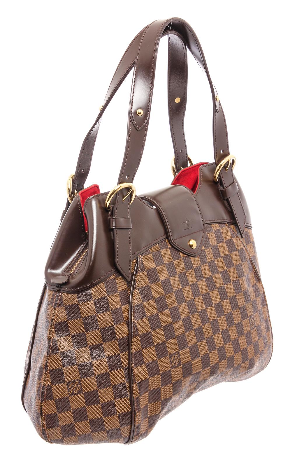 Damier Ebene Louis Vuitton Sistina PM with brass hardware, moka leather trim, dual adjustable flat shoulder straps, red Alcantara lining, dual interior slip pockets and two-way zip closures at top with logo-embossed push-lock closure at front flap.