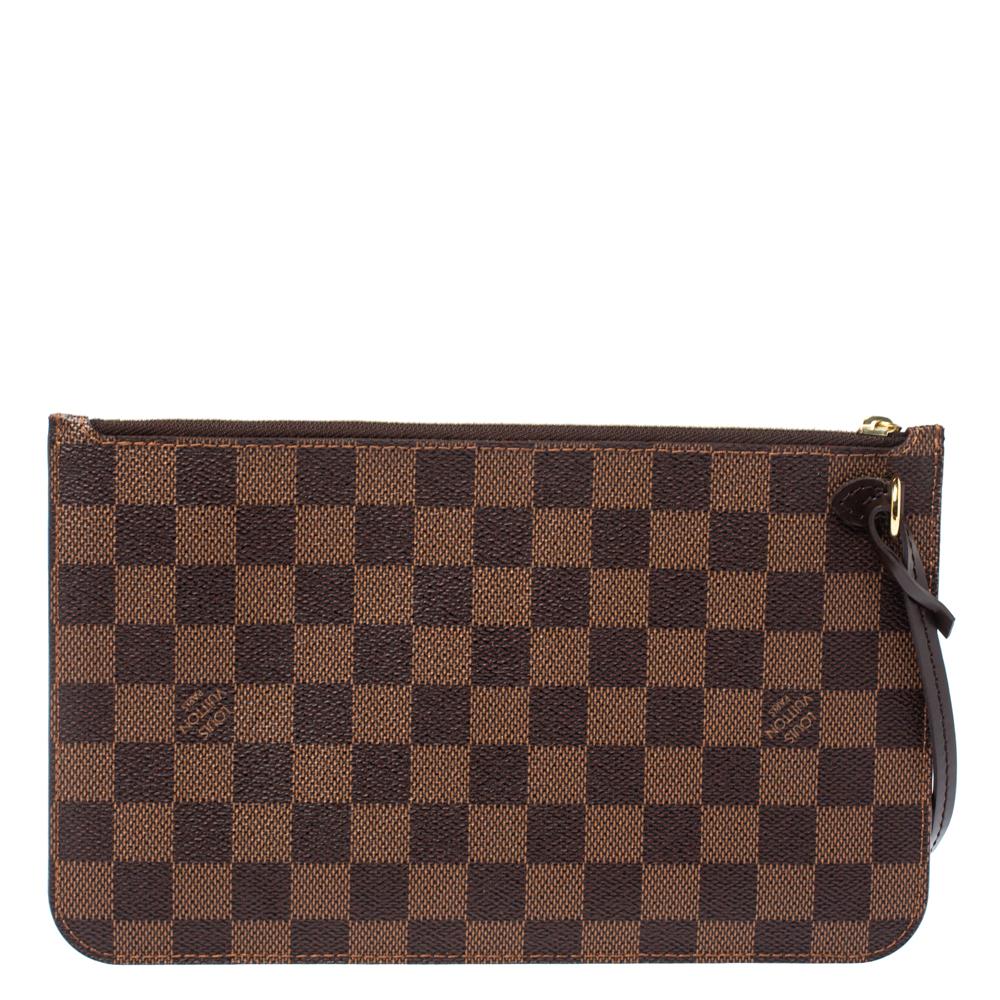 This Louis Vuitton clutch is perfect to accompany your Neverfull bags or your other designer totes. Crafted from the brand's signature Damier Ebene canvas, this clutch has a top zip closure, a canvas interior, and a leather strap holding a clasp. It