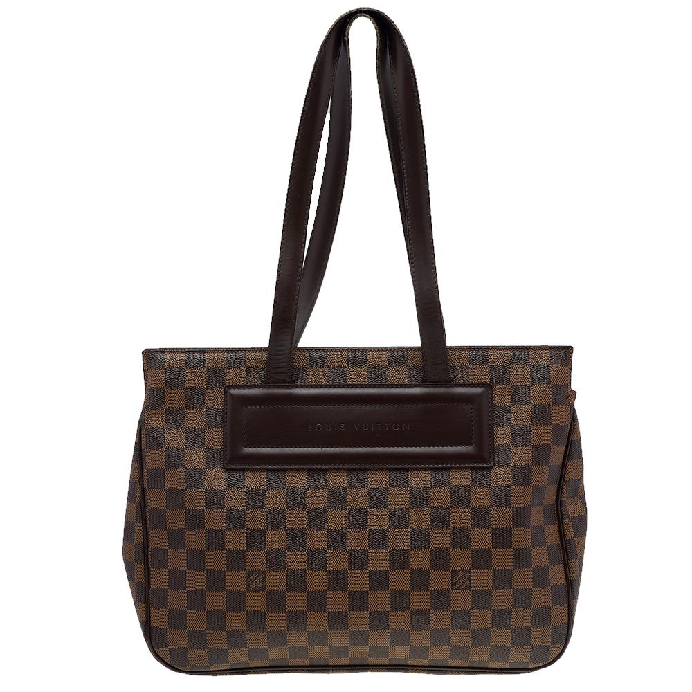 This Parioli bag by Louis Vuitton is chic, with a classy and timeless appeal. The structured exterior is made from Louis Vuitton's signature Damier Ebene canvas with contrasting leather piping. A dark brown leather patch features 'Louis Vuitton'