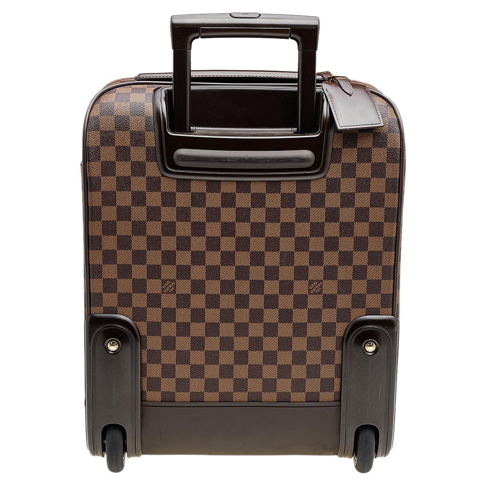 Take this Louis Vuitton luggage bag with you wherever you travel for a stylish and practical look. Made from canvas, it features the Damier Ebene print and smooth brown leather trim. This bag includes a top handle, an extendable handle, and a front