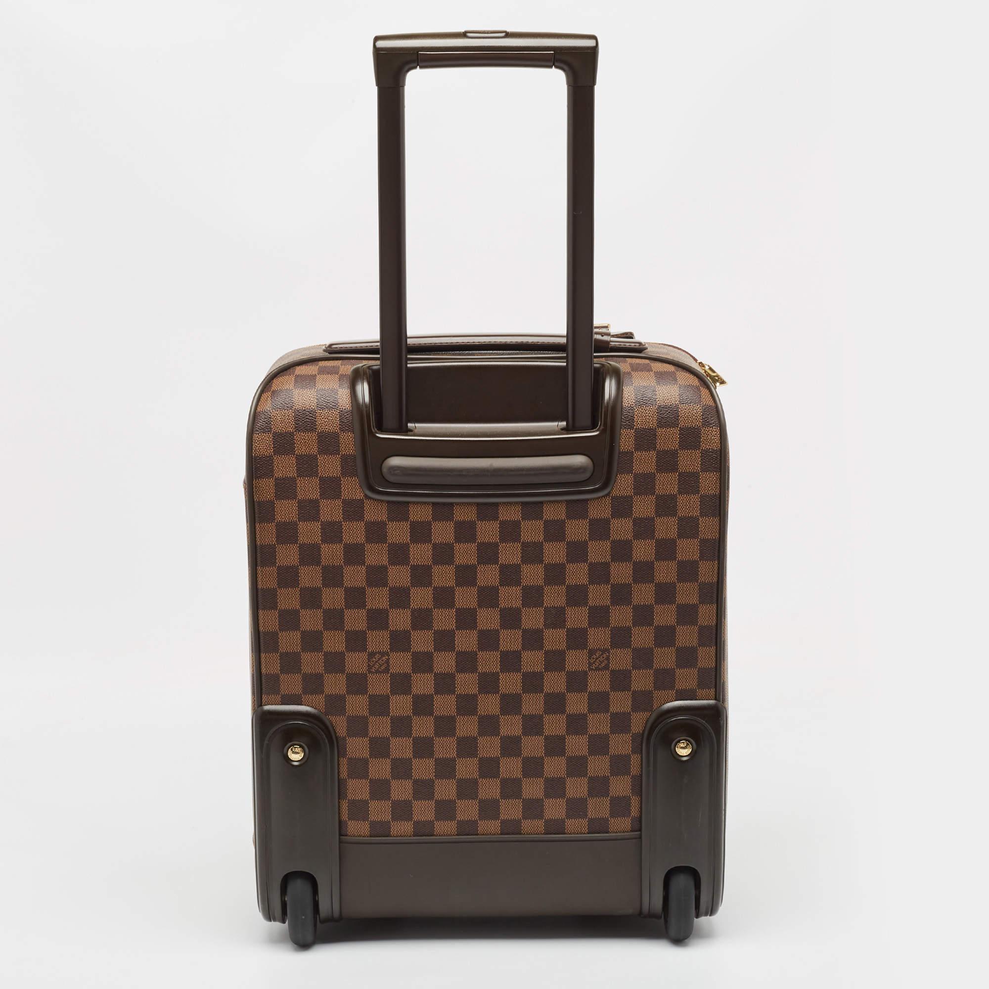 Crafted from iconic Damier Ebene canvas, the Louis Vuitton Pegase 45 luggage seamlessly merges style and functionality. Its spacious interior is complemented by multiple compartments, offering effortless organization. With smooth rolling wheels and