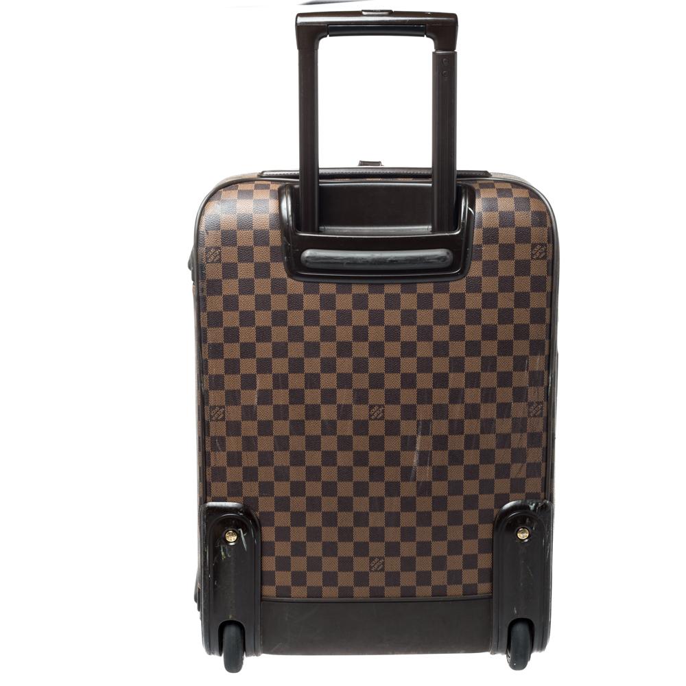 Elegantly renewing Louis Vuitton's legendary art of travel, the Pegase 55 in Damier Ebene canvas combines traditional craftsmanship with innovative, modern design. Lightweight, robust and ultra-mobile, it glides along smoothly on its two wheels,